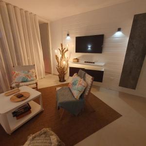 a living room with a flat screen tv on a wall at Appartement neuf design - Résidence avec piscine in Cul de Sac