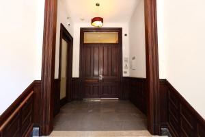 a hallway with a wooden door in a building at Stylish Newbury Street Studio, #11 in Boston