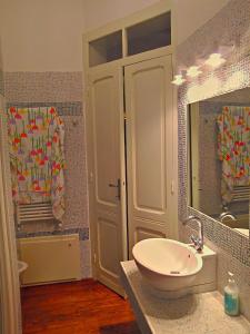 a bathroom with a sink and a mirror at Villa Giardini in Capoterra