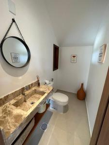 a bathroom with a sink and a toilet at Casa Aconchego - Barreirinhas in Barreirinhas +8 photos