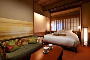 a hotel room with a bed and a couch at Yasaka Yutone Kyokoyado in Kyoto