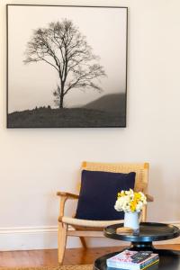 a living room with a tree picture on the wall at Ambrose On Byng - Central Location in Orange