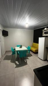 - une chambre avec une table, des chaises et un canapé dans l'établissement Quitinete ótima localização, à Foz do Iguaçu