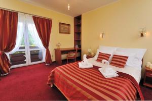 Postel nebo postele na pokoji v ubytování Hotel Na Błoniach