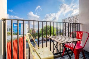 a table and chairs on a balcony with a view at MH48 Hotel in Kenting