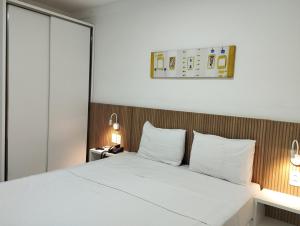 a bedroom with a large bed with white pillows at FLAT PONTA NEGRA BEACH-Natal in Natal +37 photos