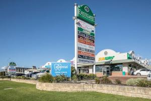 a group of signs in front of a store at Apartment 3 Burswood in Perth