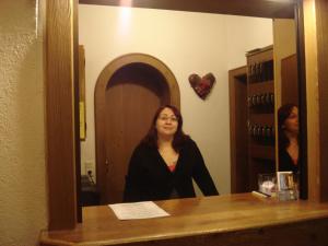 a woman standing in front of a mirror at Regerhof in Germering