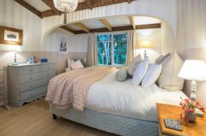 a bedroom with a large bed and a window at Woolrich House - Historic Hills Home Reimagined in Olinda