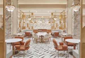 a restaurant with tables and chairs and a lobby at Grand Westside Manila Bay in Manila