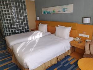 a hotel room with two beds and a telephone at Holiday Inn Express Beijing Airport Zone by IHG in Beijing +71 photos
