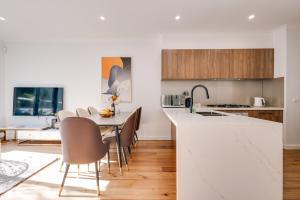 a kitchen and dining room with white countertops at StayAU Stylish Spacious 4BR Home Ringwood in Ringwood East