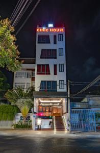 a white building with a lit up sign on it at Chiic House 6 - Khách sạn tình yêu in Vung Tau