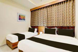 Posteľ alebo postele v izbe v ubytovaní OYO HOTEL SUN LIGHT