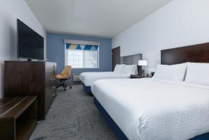 a hotel room with two beds and a flat screen tv at Holiday Inn Express Spokane-Valley, an IHG Hotel in Spokane Valley