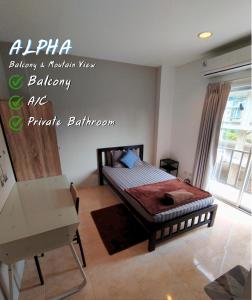 a bedroom with a bed and a writing on the wall at ALPHA Hostel Cafe&Bar in Ban Khlong Yai