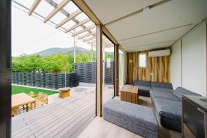 a living room with a couch and a table at グランステイ湯布院 GranStay YUFUIN in Yufu +32 photos