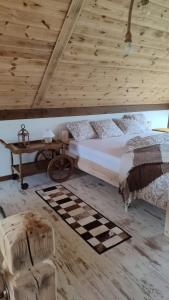a bedroom with a bed and a wooden ceiling at Pod Aniołem 2 in Dobków +12 photos