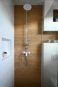 a shower in a bathroom with a wooden floor at Apartmani Vito in Biograd na Moru +86 photos