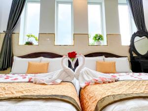 Postel nebo postele na pokoji v ubytování Gia An Hotel-Cần thơ