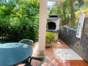 a patio with a table and an outdoor oven at Case dei limoni sul mare in Capoliveri