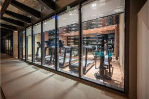 a gym with a bunch of exercise equipment in a building at The Metropole Opera Residence by KayStay in Ho Chi Minh City