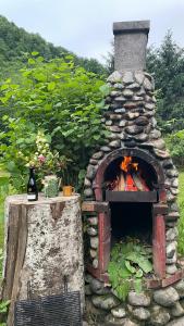 a stone oven with a fire inside of it at Cottage by the river Valea Draganului in Poeni