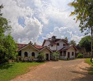 a house on the side of a road at SurfBayVilla in Dickwella