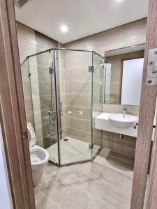 a bathroom with a shower and a toilet and a sink at Luxury Apartment-Bống Homestay in Long Bình