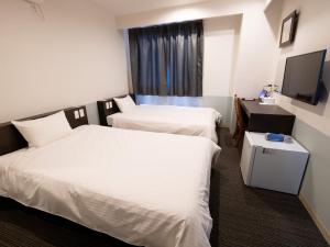 Postel nebo postele na pokoji v ubytování Hotel Taiyo Noen Tokushima Kenchomae