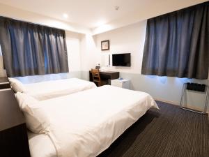 Postel nebo postele na pokoji v ubytování Hotel Taiyo Noen Tokushima Kenchomae