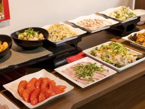 徳島市にあるHotel Taiyo Noen Tokushima Kenchomaeのテーブルの上に並ぶ様々な種類の料理を楽しめます。