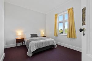 a bedroom with a bed and a window at Riverfront Motel & Restaurant in Hobart
