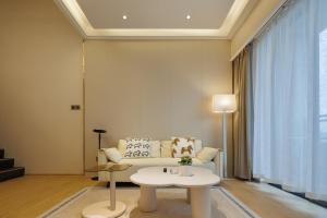a living room with a couch and a table at K Apartment Guangzhou in Guangzhou