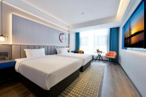 Letto o letti in una camera di Mehood Hotel Hanzhong Central Plaza