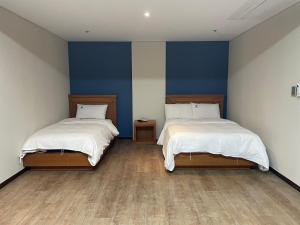 Postelja oz. postelje v sobi nastanitve Benikea Daelim Hotel