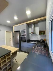 a kitchen with a sink and a counter top at Casa com banheira e lareira 12km da cidade in Santa Cruz do Sul