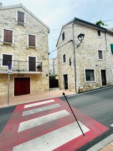 a crosswalk on a street in front of a building at Lili apartman in Vodice