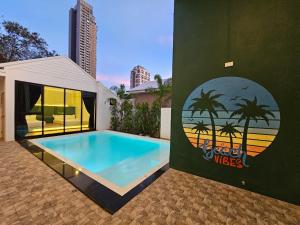a swimming pool in front of a building at Madaguscar Private Pool Villa-Pattaya in Jomtien Beach