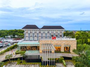 a building with a red x on top of it at Swiss-Belhotel Danum Palangkaraya in Palangkaraya