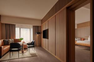 a hotel room with a bed and a table and chairs at Amara Singapore - Newly Renovated in Singapore