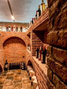 a room with bottles of wine on a brick wall at Central Hotel Kutaisi in Kutaisi