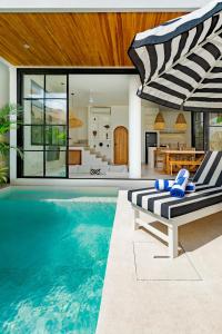 a house with a swimming pool and a patio at New Designer 2BR Villa in Canggu in Canggu