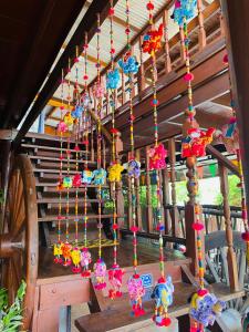 a bunch of beads hanging from a wooden structure at Banthai Guesthouse in Phetchaburi