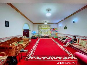 a living room with couches and a red carpet at Private Cottage in Sharjah
