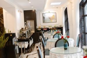 a restaurant with tables and chairs with flowers on them at Hồng Vận Hotel in Hanoi
