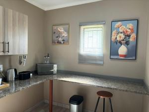 a kitchen with a counter top with a vase at Azalea Accommodation in Northam