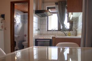 a kitchen with a sink and a stove top oven at Mamouth Studios in Chania Town +49 photos