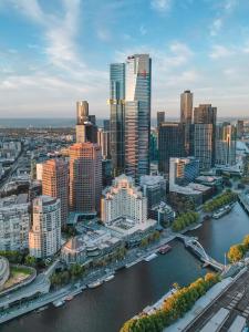 an aerial view of a city with a river and buildings at The Langham Melbourne in Melbourne