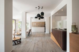 a living room with white walls and wooden floors at Marina Garden Hotel in Marciana Marina